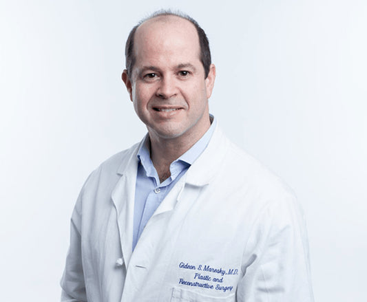 A portrait of a person wearing a white lab coat with the name 'Gideon S. Maresky, MD' printed on the chest.